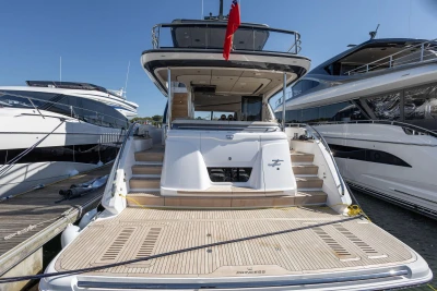 Luxury yacht Princess Y72, 2026 model, docked between two other yachts.