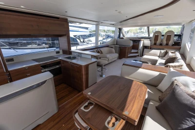 Luxurious interior of 2026 Princess Y72 yacht with modern kitchen and seating area.