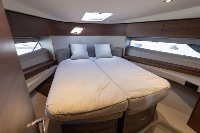Luxurious cabin interior of 2025 Princess F50 yacht with cozy bed and modern design.