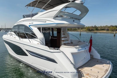 Luxury 2025 Princess F50 yacht on serene water, showcasing sleek design and elegance.