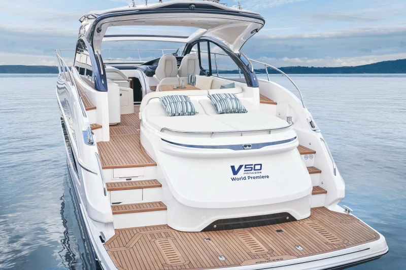 2026 Princess V50 Open yacht on serene water, showcasing luxurious deck and seating.