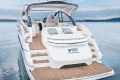 2026 Princess V50 Open yacht on serene water, showcasing luxurious deck and seating.