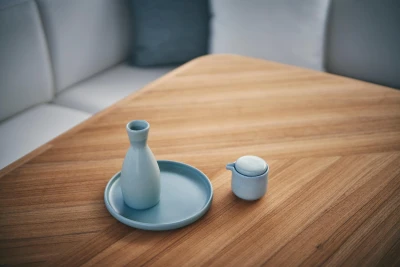 Minimalist wooden table with blue ceramic vase and cup, aboard 2026 Princess V50 Open yacht.