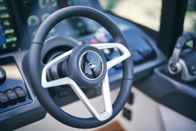 Steering wheel of 2026 Princess V50 Open yacht, featuring modern dashboard controls.
