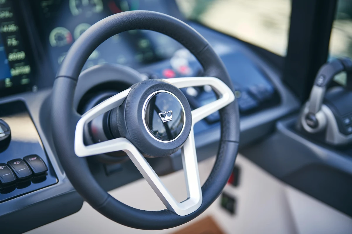 Steering wheel of 2026 Princess V50 Open yacht, featuring modern dashboard controls.