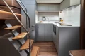Modern kitchen interior of 2026 Princess V50 Open yacht, featuring sleek design and wooden accents.