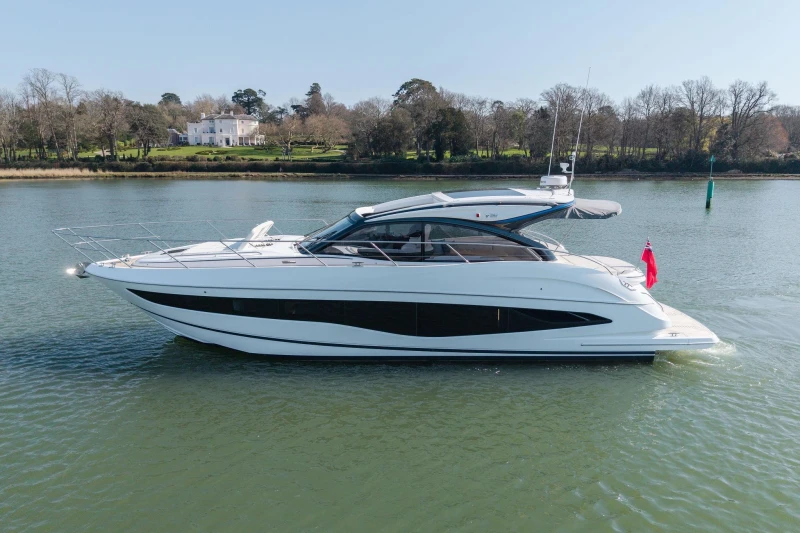 2026 Princess V50 Open yacht on serene water with scenic background.