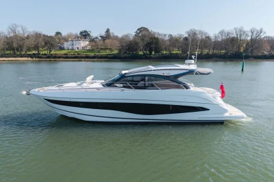 2026 Princess V50 Open yacht on serene water with scenic background.