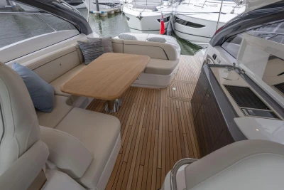 Luxurious 2026 Princess V50 Open yacht interior with elegant seating and wooden flooring.