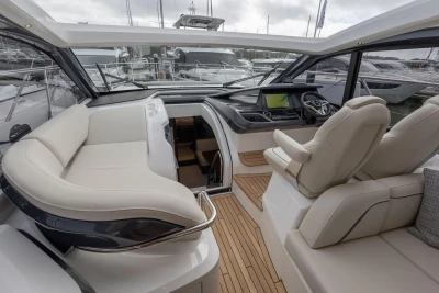 Luxurious interior of 2026 Princess V50 Open yacht with plush seating and modern dashboard.