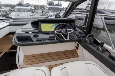 Helm of 2026 Princess V50 Open yacht with modern navigation controls and steering wheel.