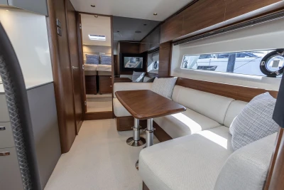 Luxurious interior of 2026 Princess V50 Open yacht with elegant seating and wooden finishes.