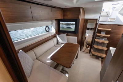 Luxurious interior of 2026 Princess V50 Open yacht with elegant wood finishes and comfortable seating.