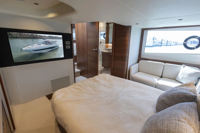 Luxurious interior of 2026 Princess V50 Open yacht with cozy bedroom and modern amenities.