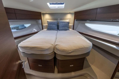 Luxurious cabin interior of 2026 Princess V50 Open yacht with cozy bedding.