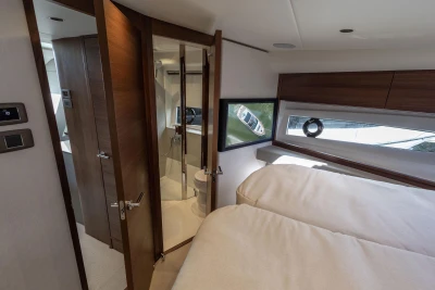 Luxurious interior of 2026 Princess V50 Open yacht with modern bedroom and bathroom.