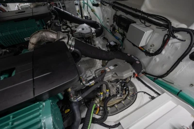 Engine room of 2026 Princess V50 Open yacht, showcasing mechanical components and wiring.