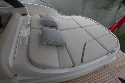 Luxurious sunbed on 2026 Princess V50 Open yacht with striped cushions.