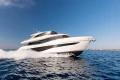 Luxurious 2026 Princess X80 yacht cruising on open sea under clear blue sky.
