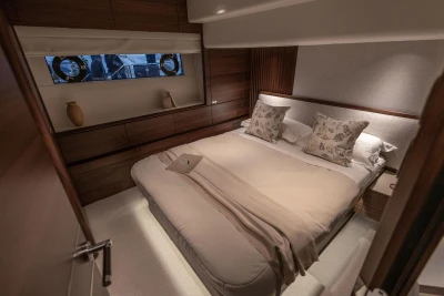 Luxurious bedroom interior of 2026 Princess X80 yacht with elegant decor and cozy bedding.