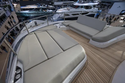 Luxurious deck seating on 2026 Princess X80 yacht at a boat show.