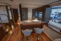 Luxurious interior of 2026 Princess X80 yacht with modern kitchen and seating area.