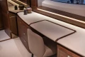 Luxurious interior of 2026 Princess X80 yacht with elegant wooden cabinetry and modern decor.