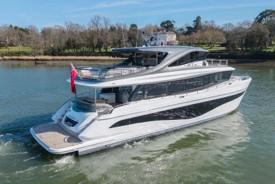 Luxurious 2026 Princess X80 yacht cruising on a serene river.