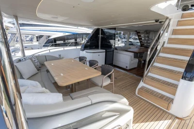 Luxurious 2026 Princess X80 yacht interior with elegant seating and wooden staircase.