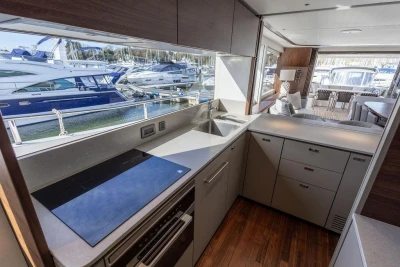 Modern kitchen interior on 2026 Princess X80 yacht, featuring sleek design and marina view.