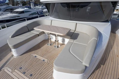 Luxurious seating area on 2026 Princess X80 yacht with elegant wooden deck.