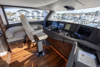 Luxurious 2026 Princess X80 yacht cockpit with advanced navigation systems and plush seating.
