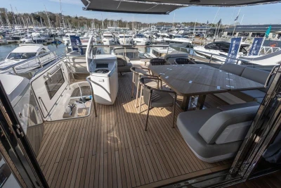 Luxurious 2026 Princess X80 yacht deck with elegant seating and dining area.