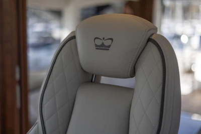 Luxurious leather seat with crown emblem in 2026 Princess X80 yacht.