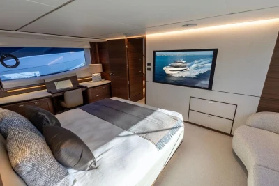 Luxurious bedroom interior of 2026 Princess X80 yacht with modern decor and large window.