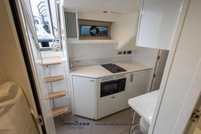Modern kitchen interior of 2026 Princess X80 yacht with compact appliances and sleek design.
