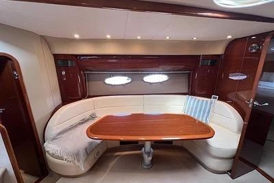 Luxurious interior of 2007 Princess V48 yacht with elegant seating and wooden table.