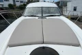 2007 Princess V48 yacht with spacious sunbathing deck in marina setting.