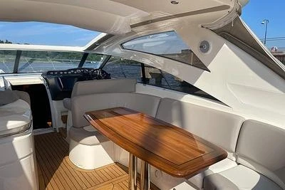 2007 Princess V48 yacht interior with elegant seating and wooden table.