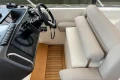 2007 Princess V48 yacht helm with beige seating and wooden flooring.