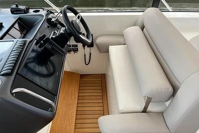 2007 Princess V48 yacht helm with beige seating and wooden flooring.
