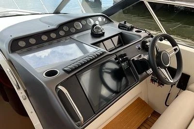 2007 Princess V48 yacht helm with modern navigation controls and steering wheel.