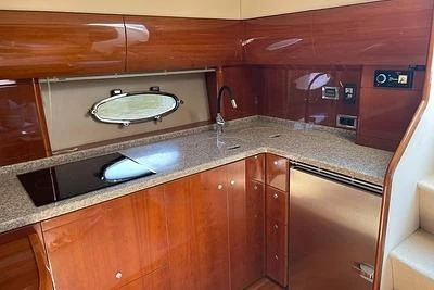 2007 Princess V48 yacht kitchen with wood cabinetry and modern appliances.