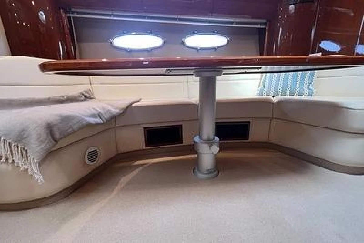 Luxurious 2007 Princess V48 yacht interior with elegant seating and table.