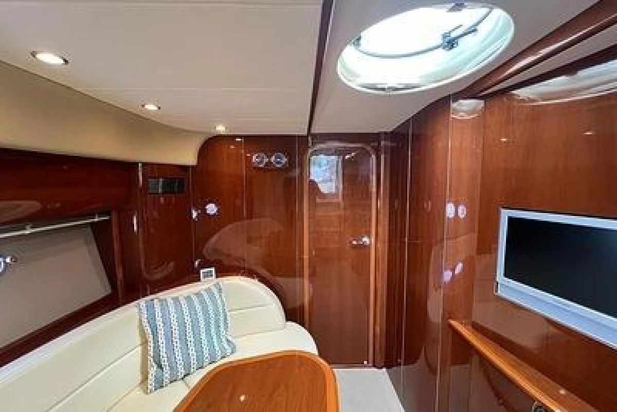 Luxurious interior of 2007 Princess V48 yacht with wood paneling and modern amenities.
