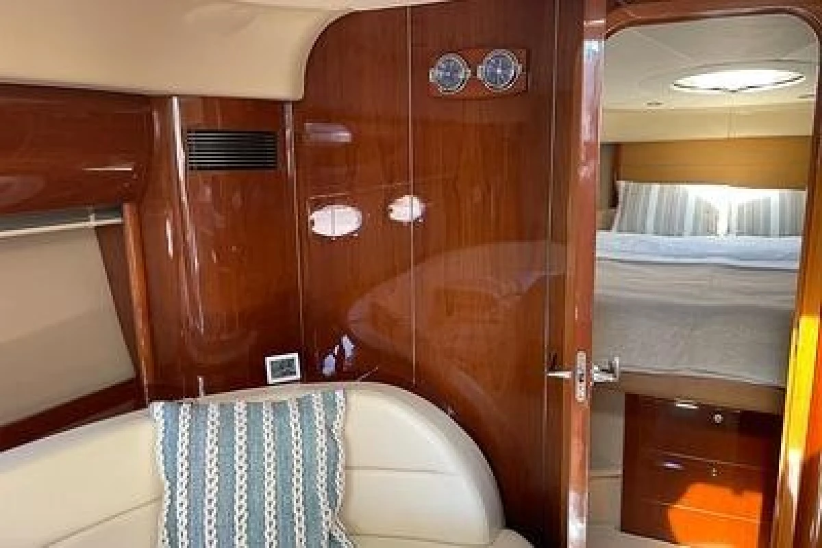 Luxurious interior of a 2007 Princess V48 yacht with polished wood and cozy seating.
