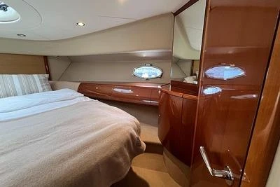 Luxurious cabin interior of 2007 Princess V48 yacht with elegant wood finish.