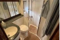 2007 Princess V48 yacht bathroom with shower, sink, and wooden flooring.