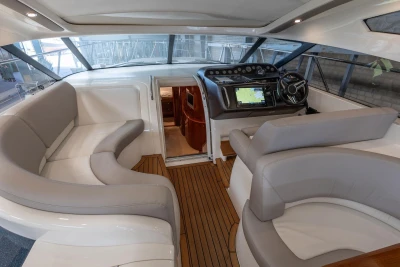 Luxurious 2007 Princess V48 yacht interior with plush seating and modern navigation controls.