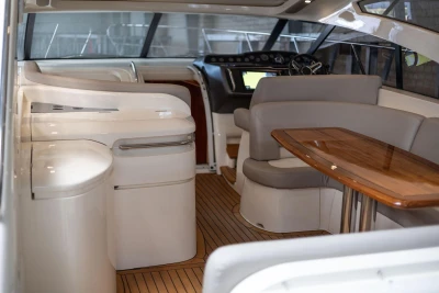 Interior of a 2007 Princess V48 yacht with elegant seating and wooden table.